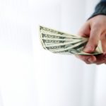 Closeup portrait of a male hand giving money